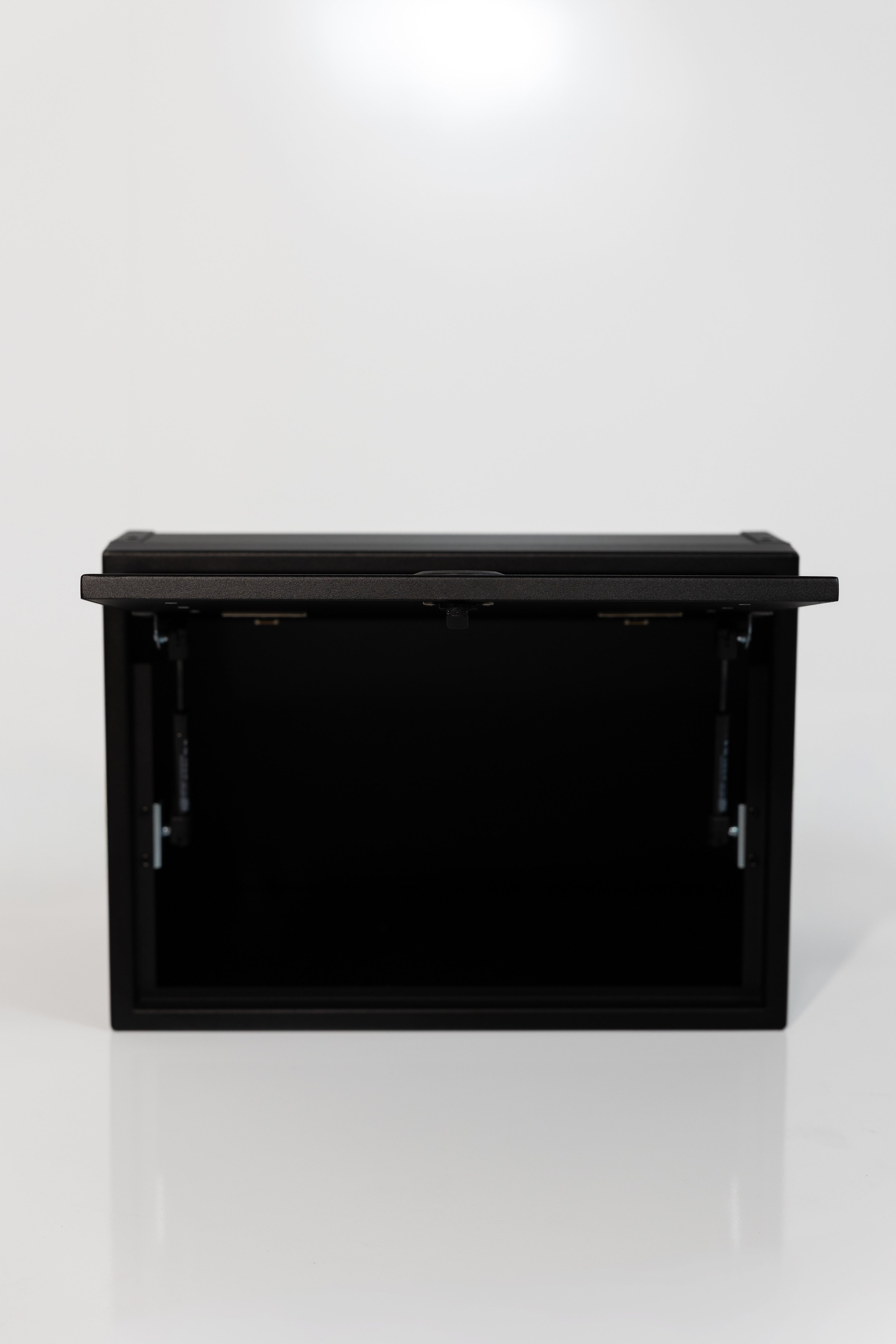 Black 21-inch wide aluminum angled upper Van Wife Components cabinet with a single shaker-style door & flush slam latch