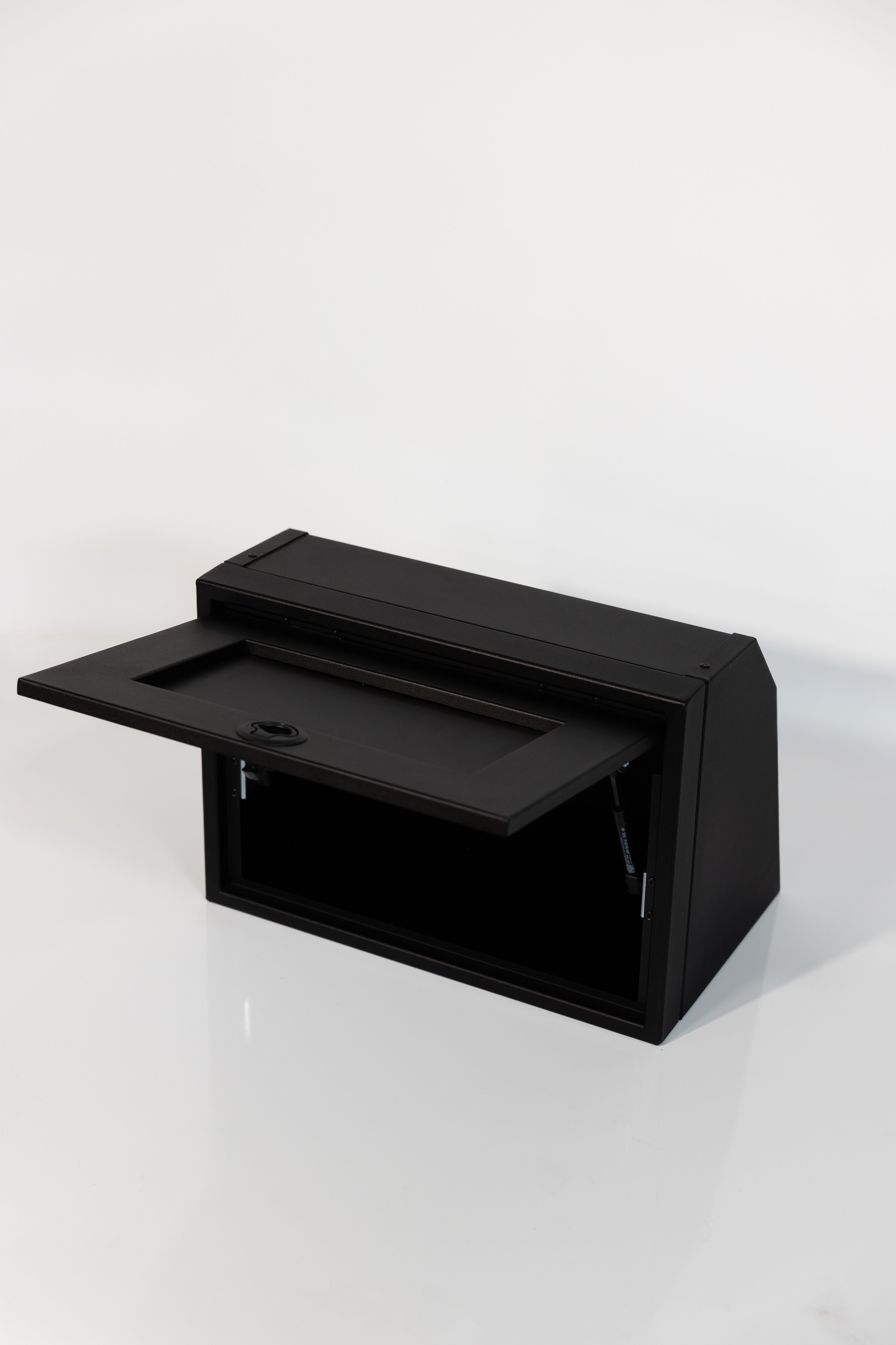 Black 21-inch wide aluminum angled upper Van Wife Components cabinet with a single shaker-style door & flush slam latch