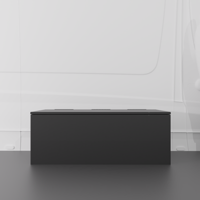 Black 42" x 22” x 16” aluminum storage bench with flip-top lid installed in a van interior.
