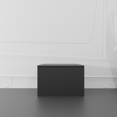 Black 24" x 22” x 16” aluminum storage bench with flip-top lid installed in a van interior.

