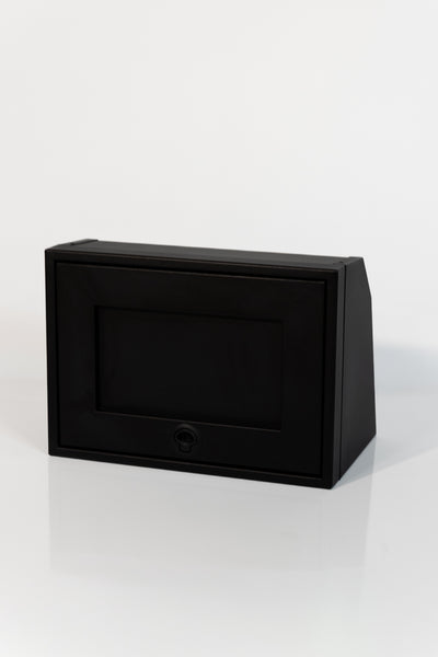 Black 21-inch wide aluminum angled upper Van Wife Components cabinet with a single shaker-style door & flush slam latch 