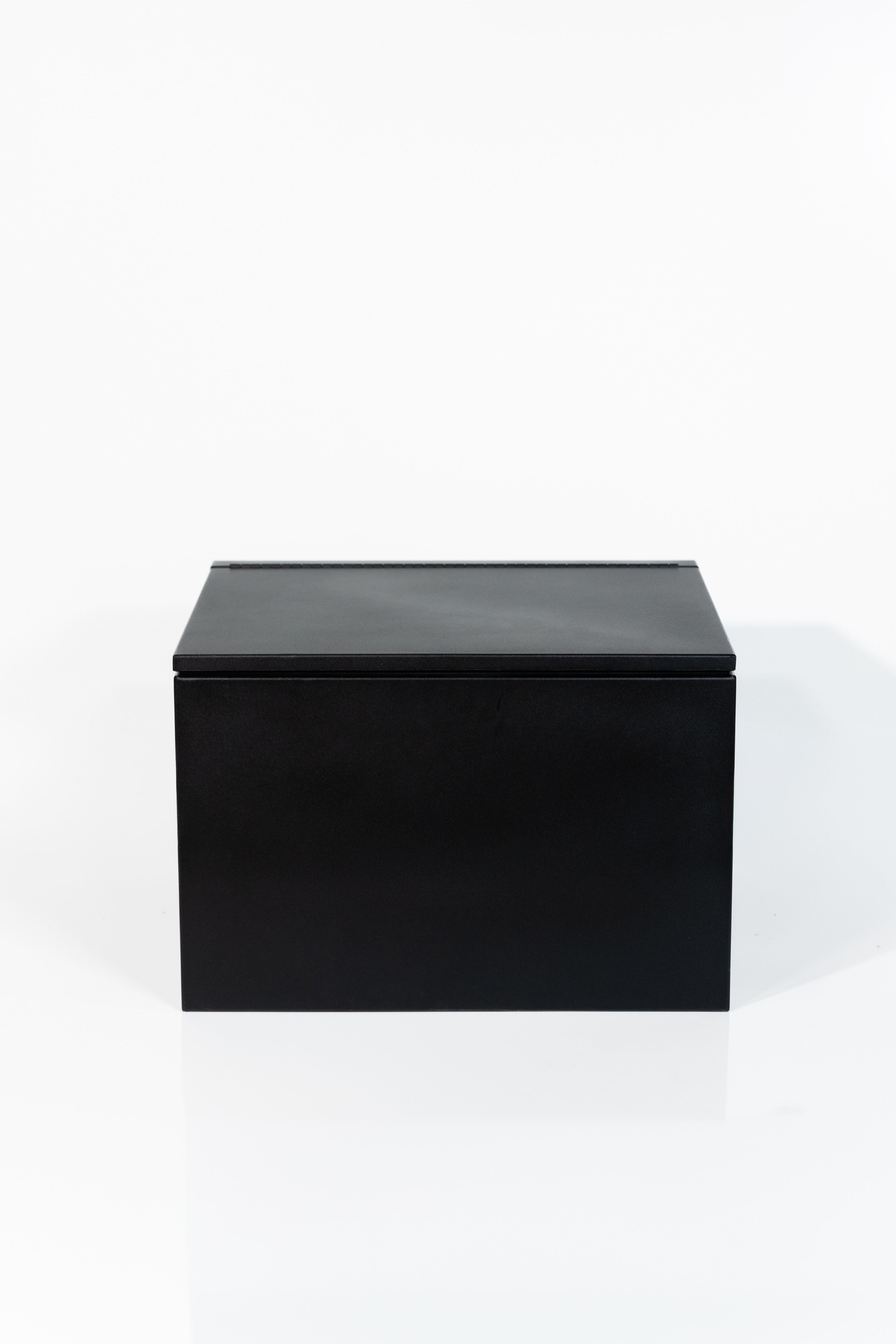 Black 24" x 22” x 16” aluminum storage bench with flip-top lid 
