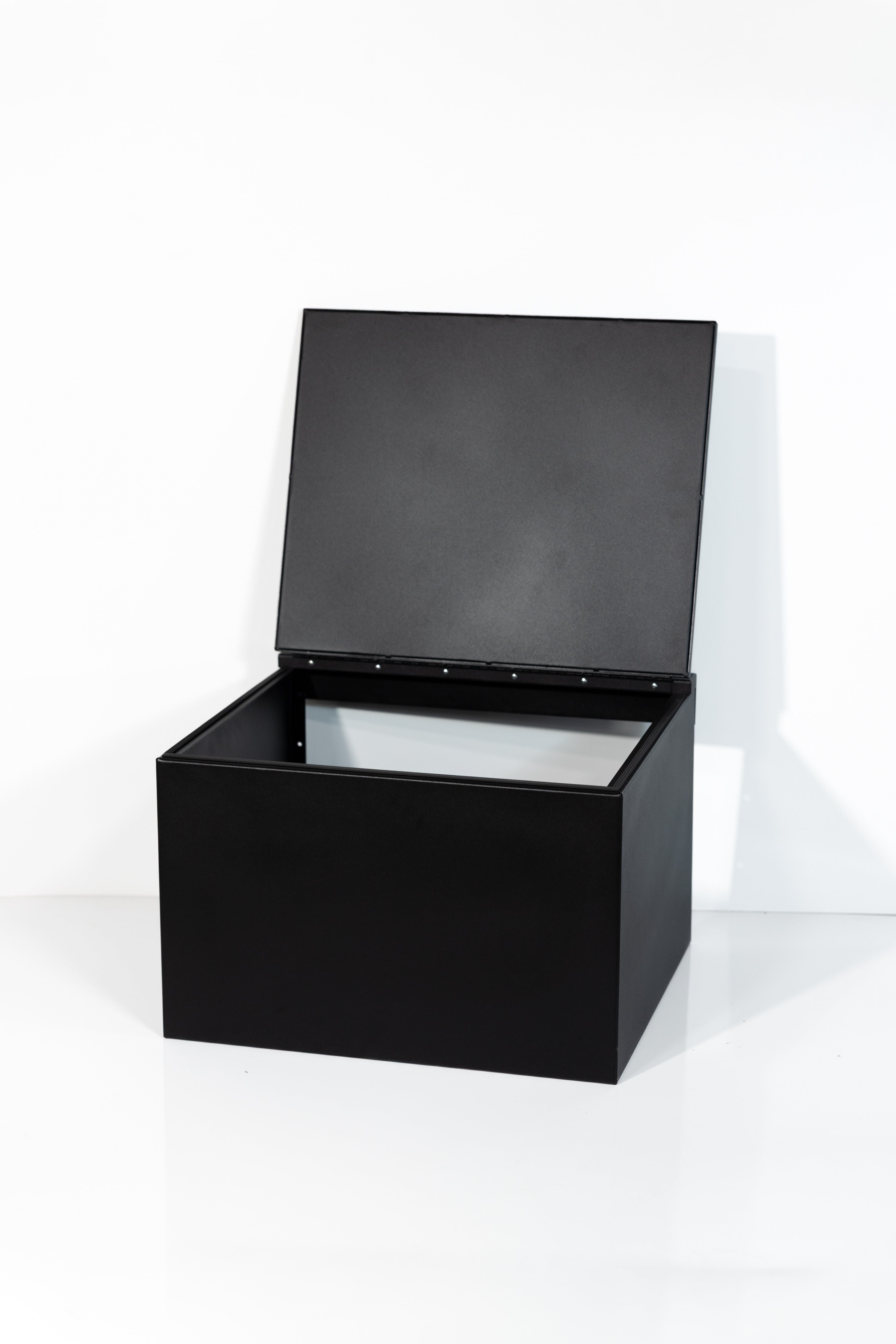 Black 24" x 22” x 16” aluminum storage bench with flip-top lid 
