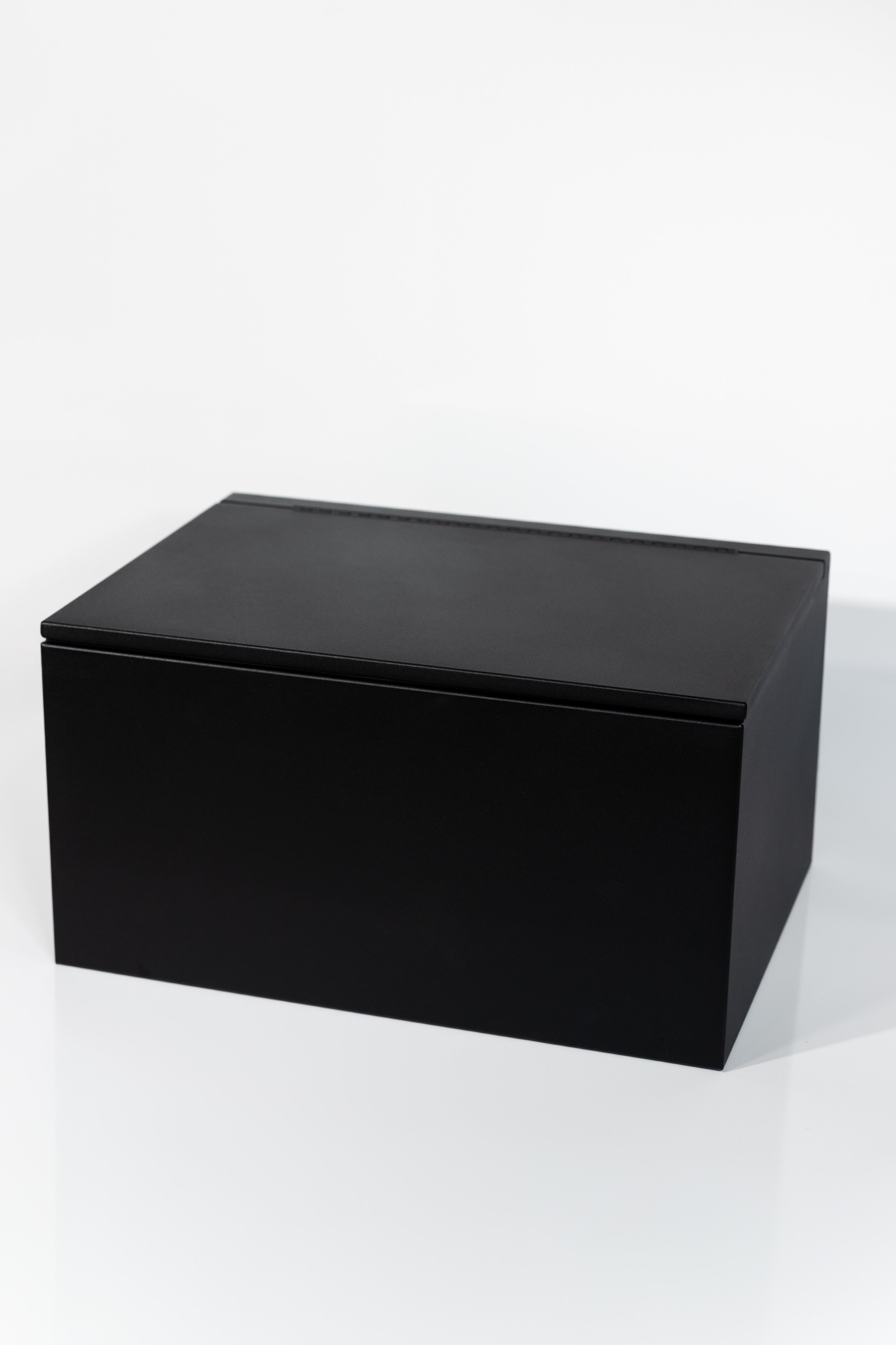 Black 30" x 22” x 16” aluminum storage bench with flip-top lid 
