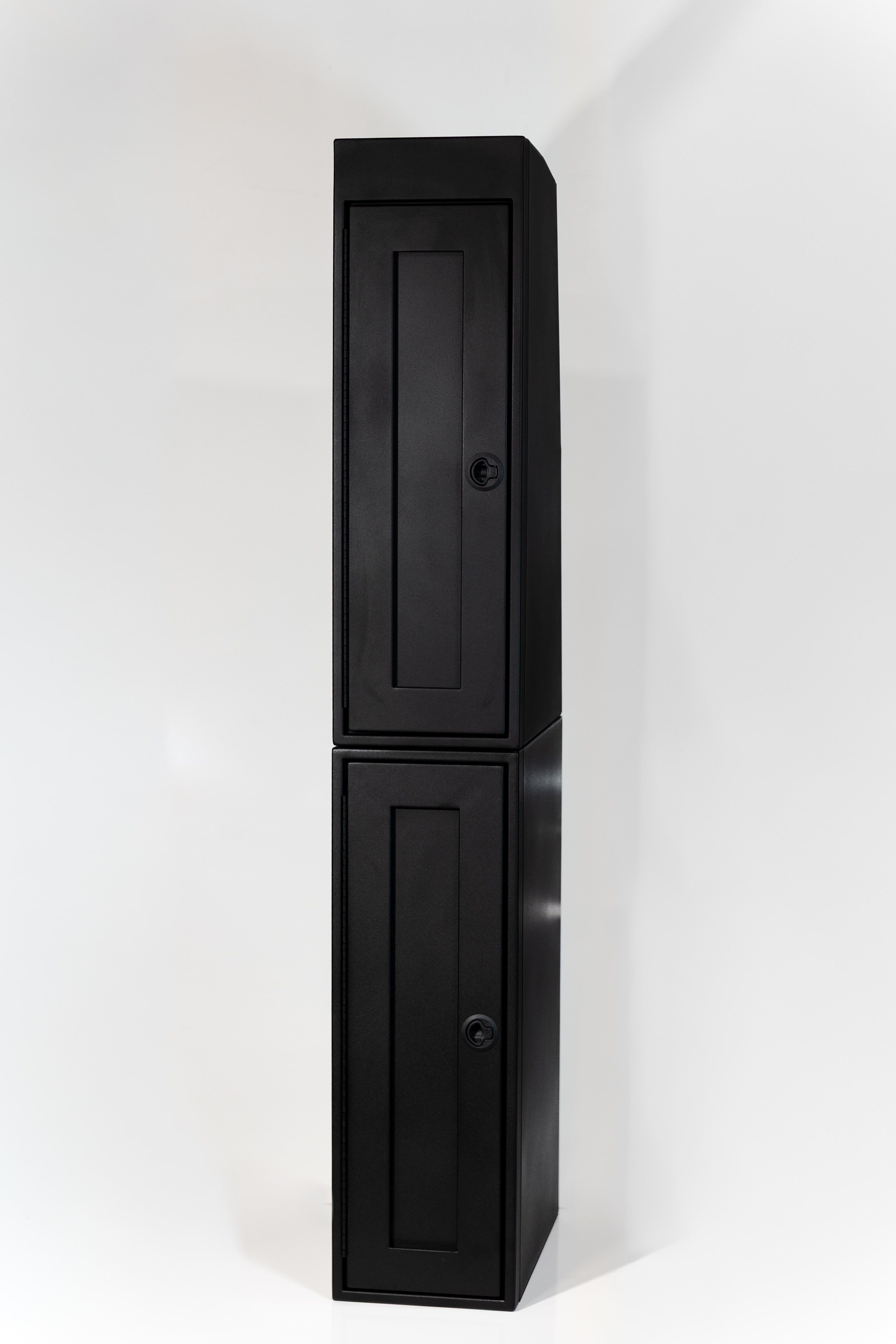 Black 12-inch wide vertical aluminum upper van closet showing a single shaker-style door with flush slam latch on top of 12 inch wide base cabinet