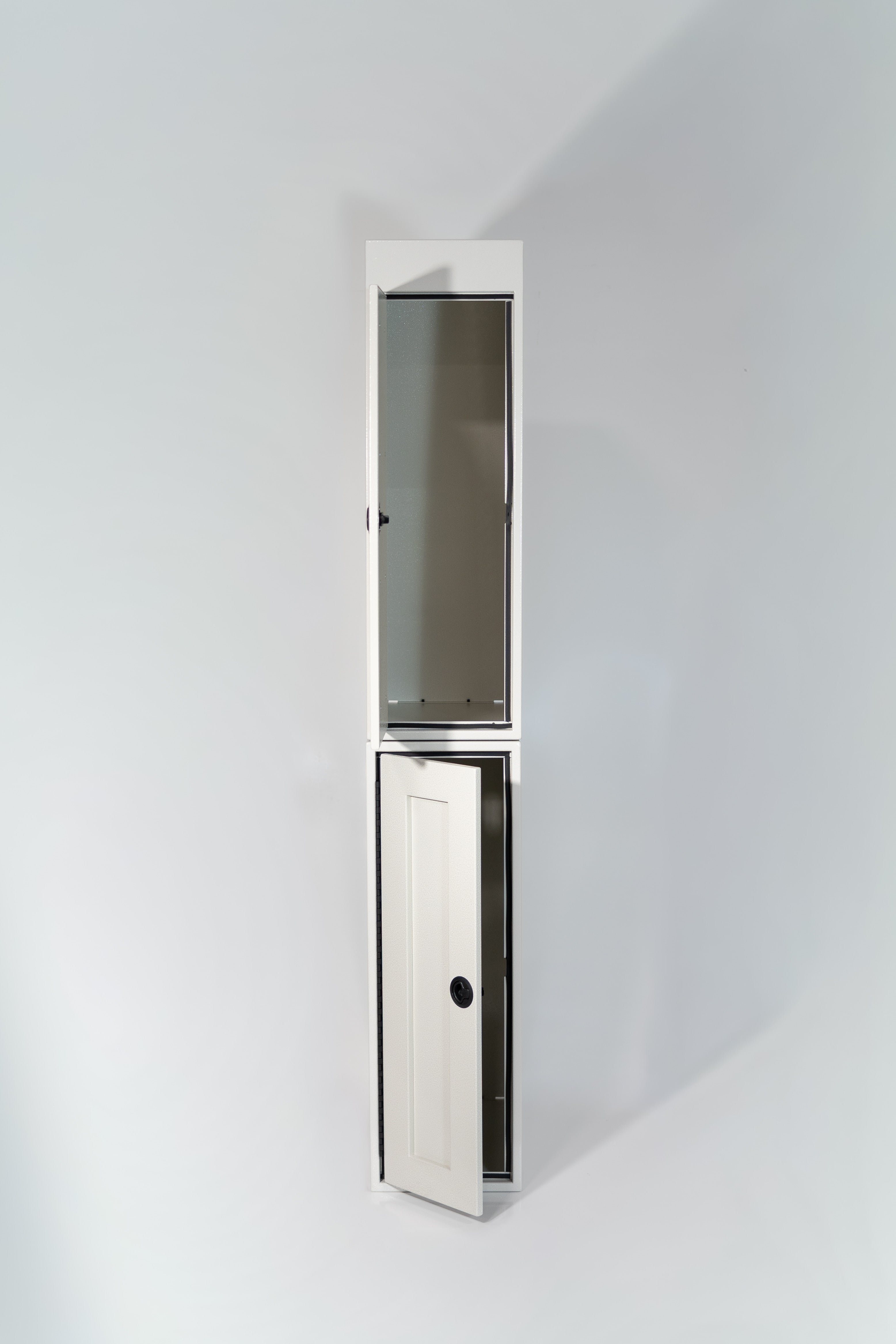 White 12-inch wide vertical aluminum upper van closet showing a single shaker-style door with flush slam latch on top of 12 inch base cabinet