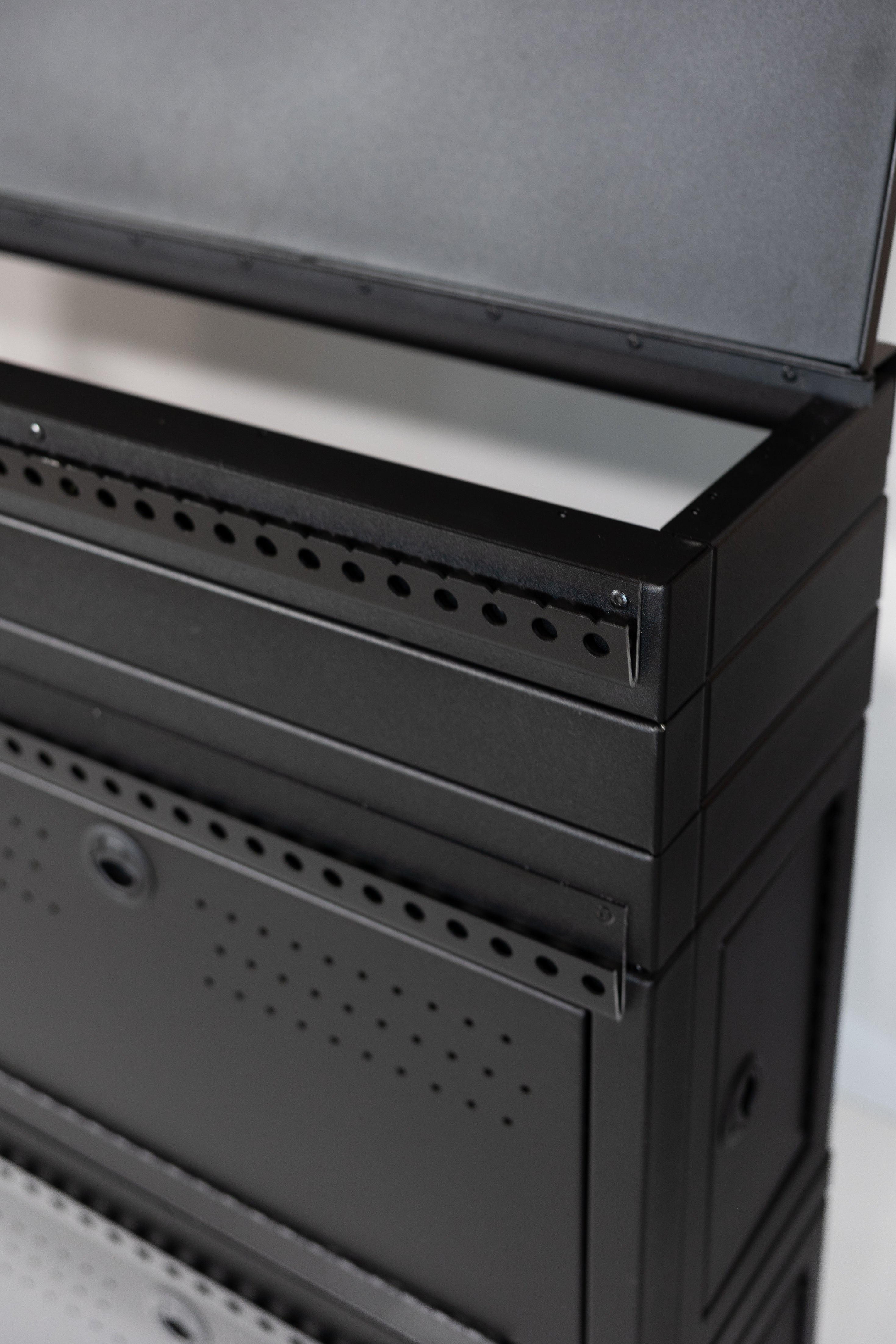 Fully assembled Black 12" wheel well covers - Stacked 2 levels high with optional risers, divider shelf, paired with hinged lid for a complete, finished look.
